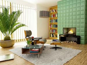 Wohnzimmer mit Kamin, grüngepolsterter Wand und Sessel mit Fußhocker