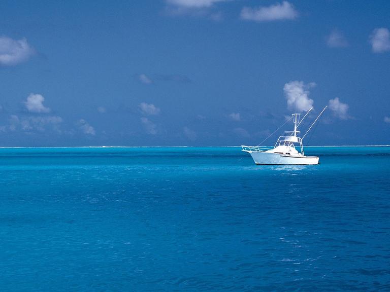 Eine weiße Yacht liegt auf dem Wasser