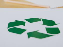 Grünes Recyclingzeichen, drei Pfeile ergeben ein Dreieck