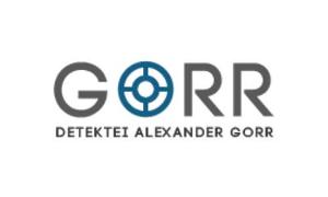 Firmenname in grau, das O wird durch ein türkises Fadenkreuz dargestellt
