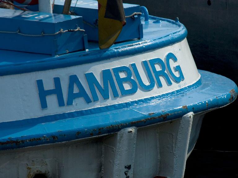 Blauweiße Barkasse mit dem Schriftzug Hamburg