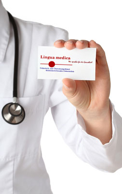 Ein Mensch in einem weißen Kittel hält eine Visitenkarte von der Lingua Medica GmbH in der Hand- und zeigt diese in die Kamera