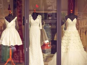 Drei weiße Kleider an Kleiderpuppen, in einem Schaufenster