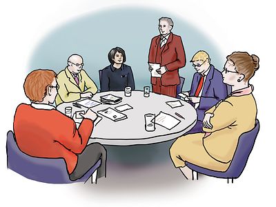  Eine Personengruppe an einem runden Tisch