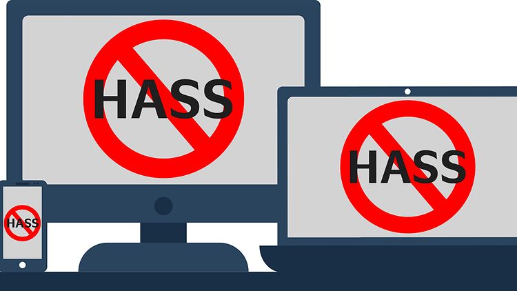  Das Wort "Hass" ist rot durchgestrichen auf einem PC-, Laptop-, Tablet- und Smartphonebildschirm.