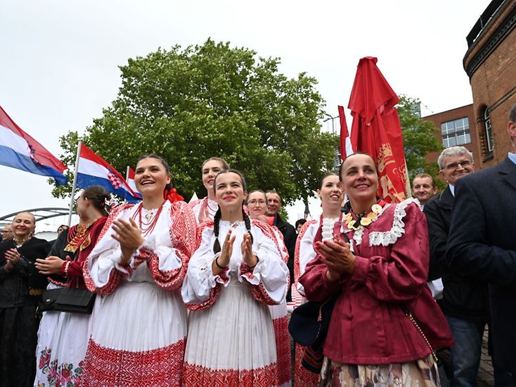  Kroatische Tänzerinnen applaudieren in ihren feierlichen Trachten.