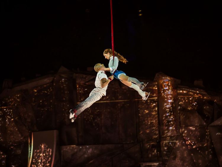  Ein Mann und eine Frau schweben in der Luft während einer Akrobatik-Show.