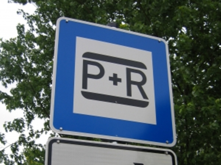  Ein Straßenschild auf dem das Park & Ride Zeichen in schwarz auf weiß zu sehen ist.