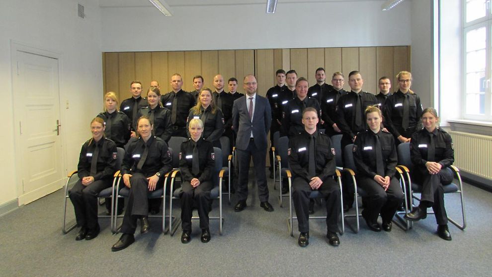 Gruppenbild mit Justizsenator Dr. Till Steffen und allen Nachwuchskräften in Uniform 